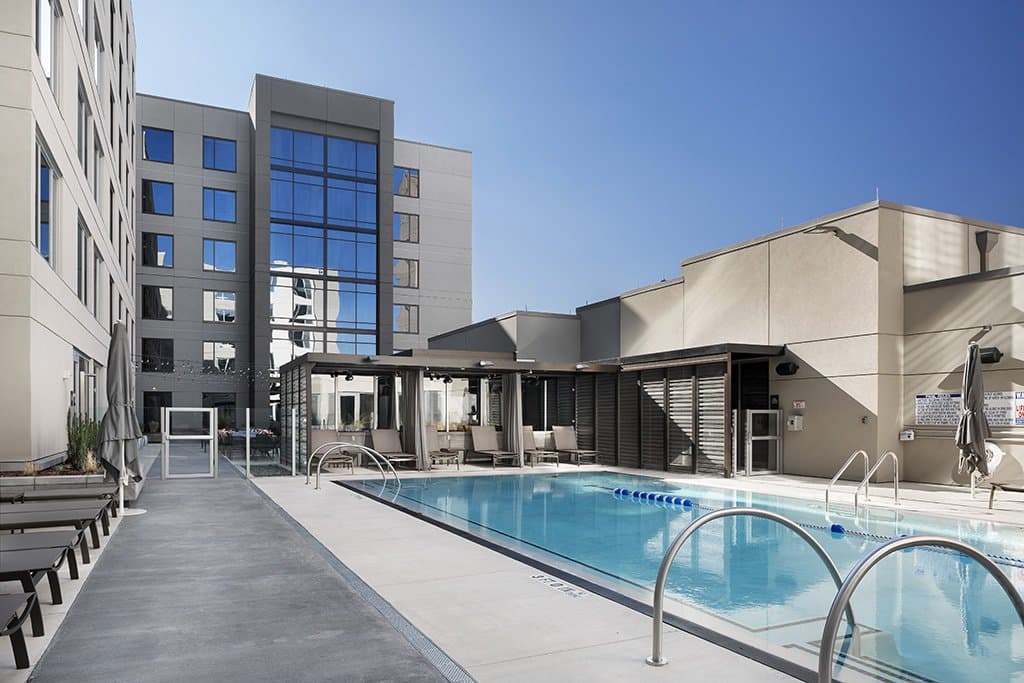 A glistening blue pool surrounded by the walls of the AC/Moxy Hotel in Midtown, Atlanta. 