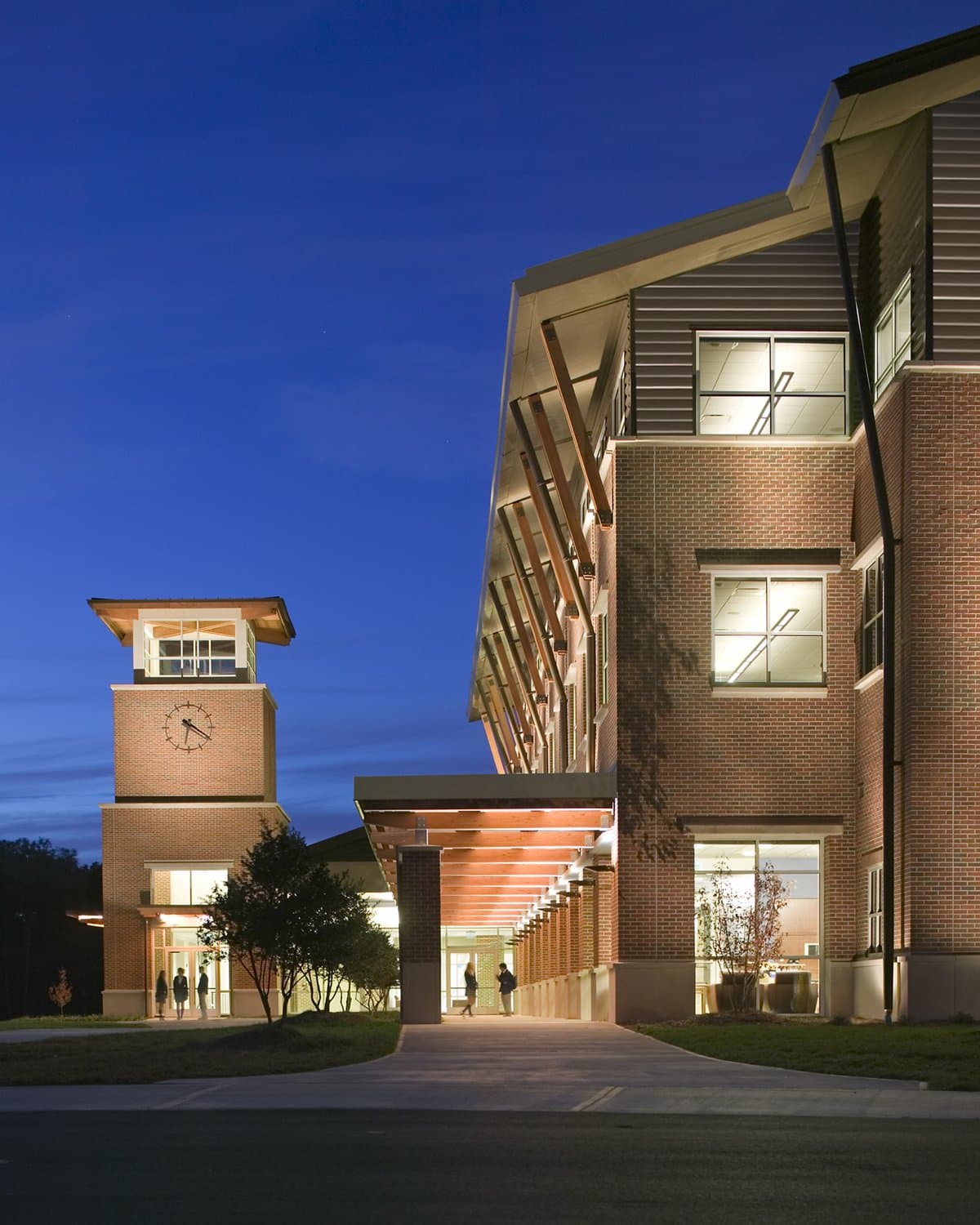 A well-lit walkway leading to the entrance of Mt. Vernon Presbyterian School at dusk.