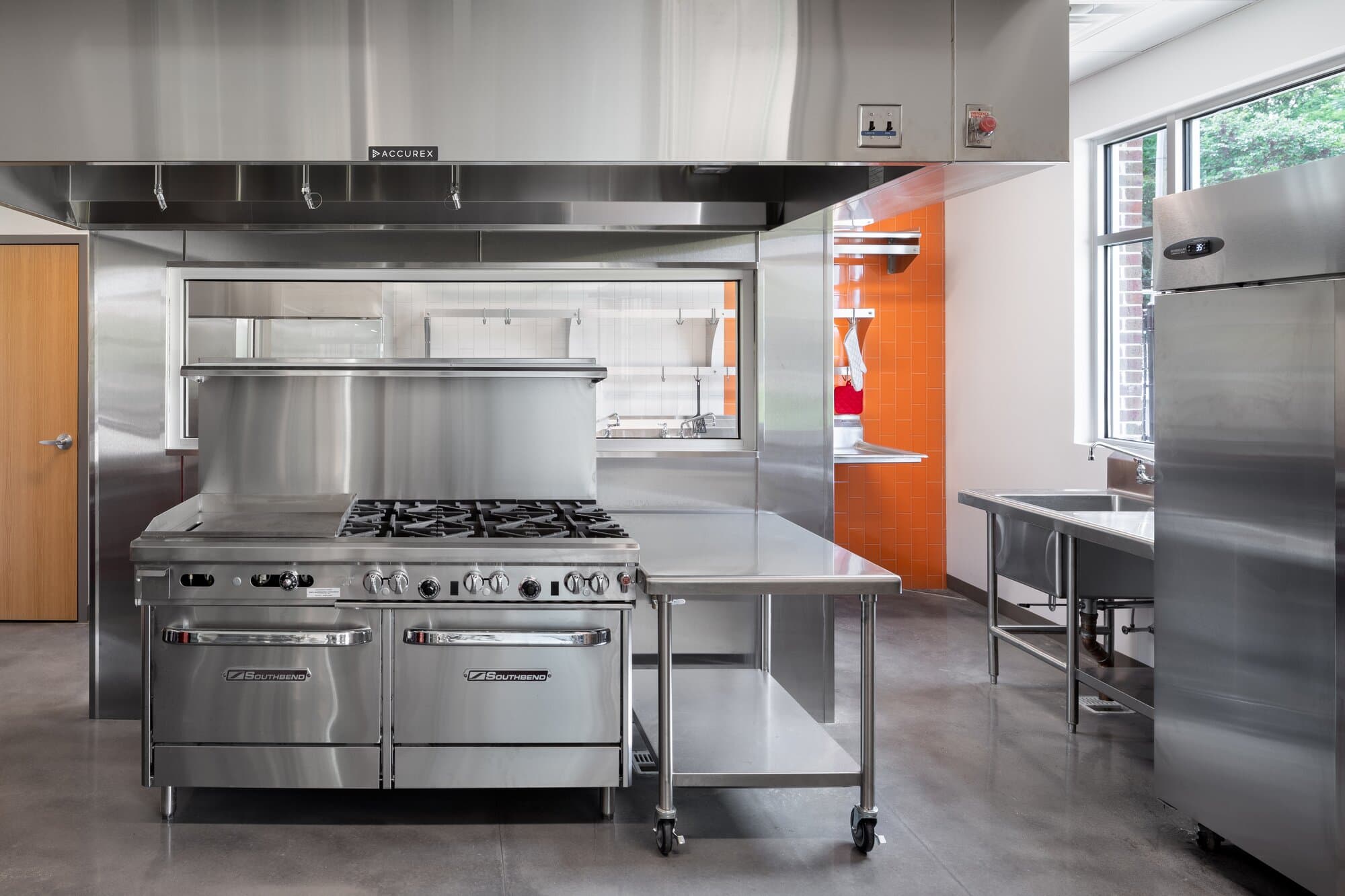Kitchen and prep area with  commercial grade kitchen appliances and counters.