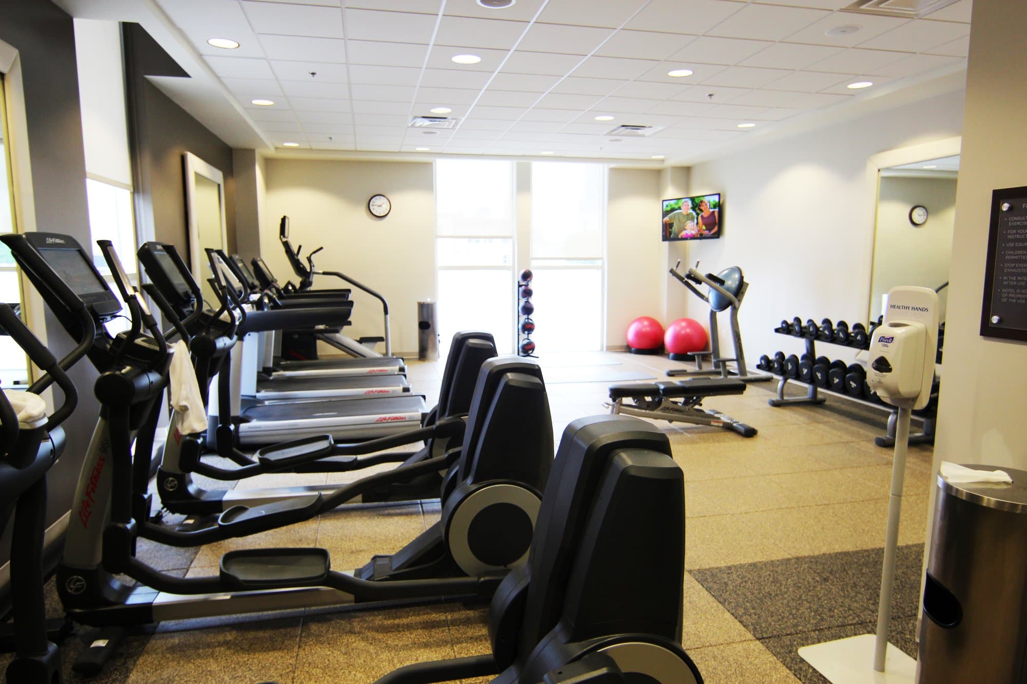 Row of exercise equipment in a hotel gym.