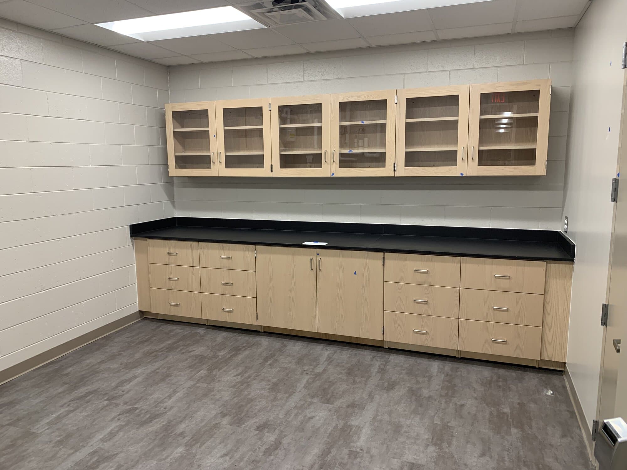 Room with door inside lab classroom offering additional above cabinet space and coutner space.