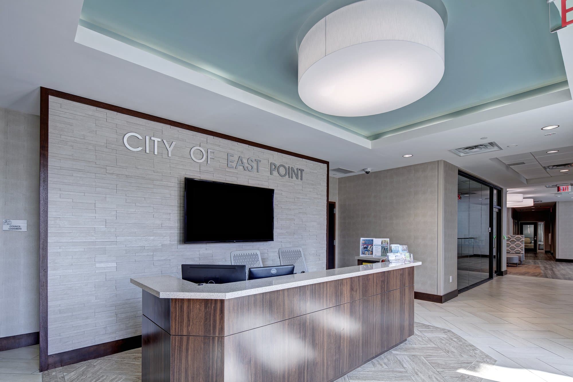 Front desk with a sign reading city of east point behind it.