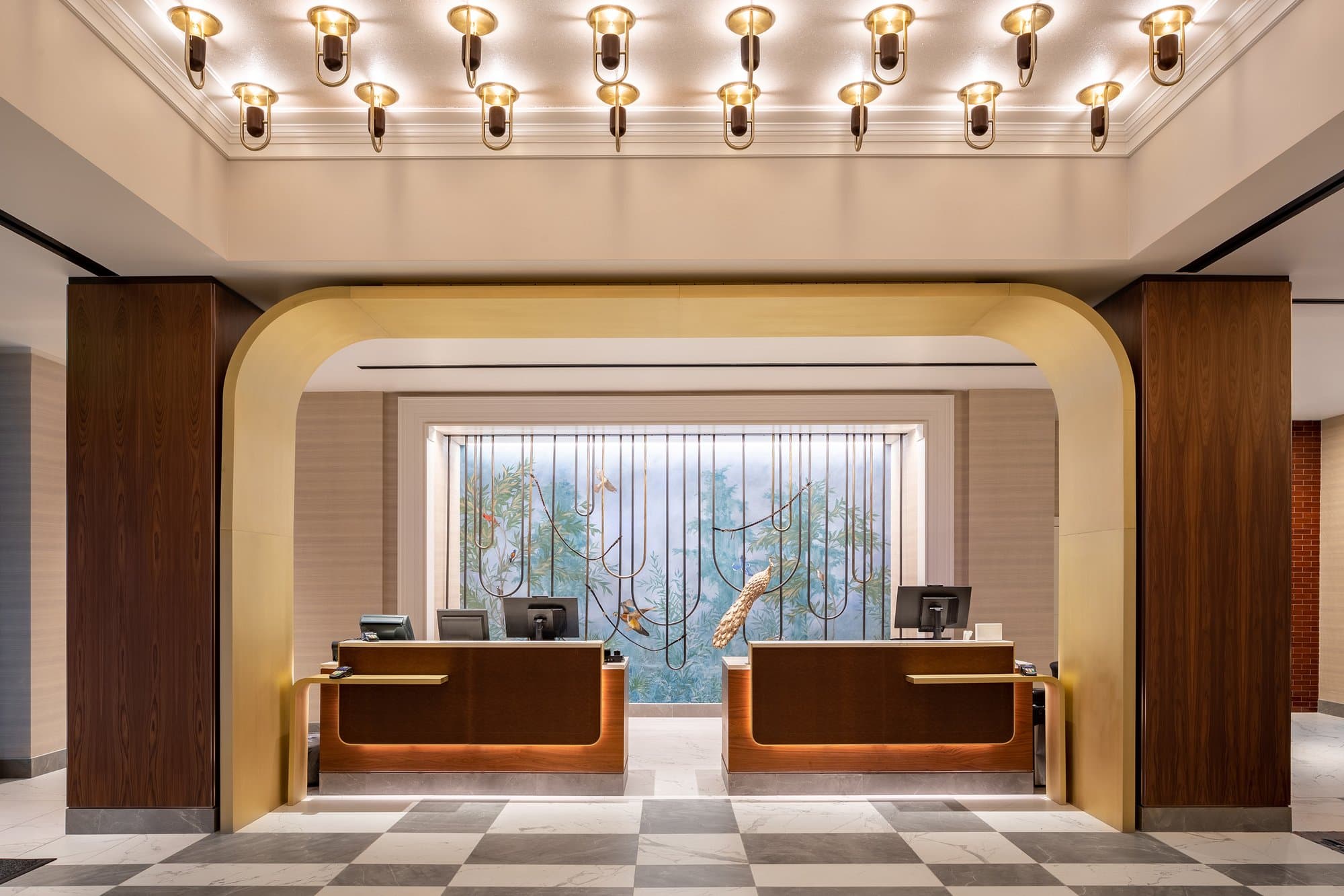 The lobby of a hotel with a checkered floor.