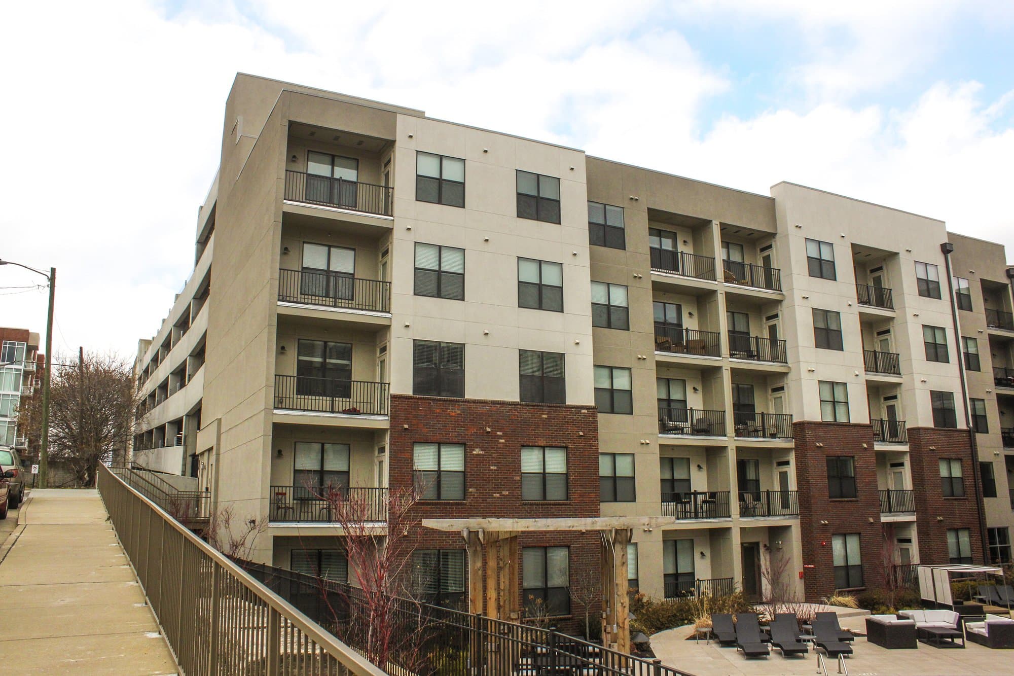 Side view of multi-family residence overlooking pool area.