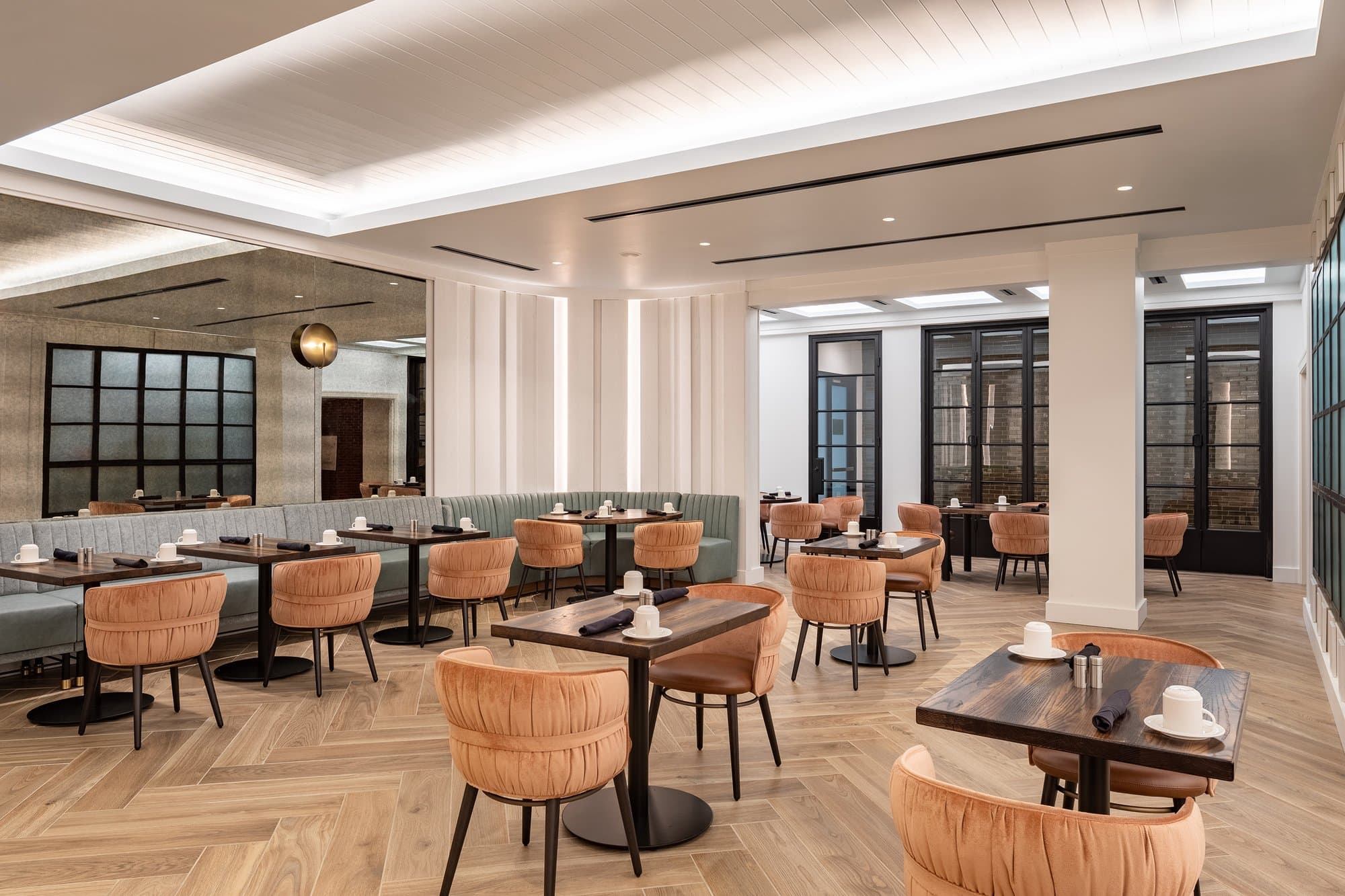 A restaurant with tables and chairs in a modern setting.