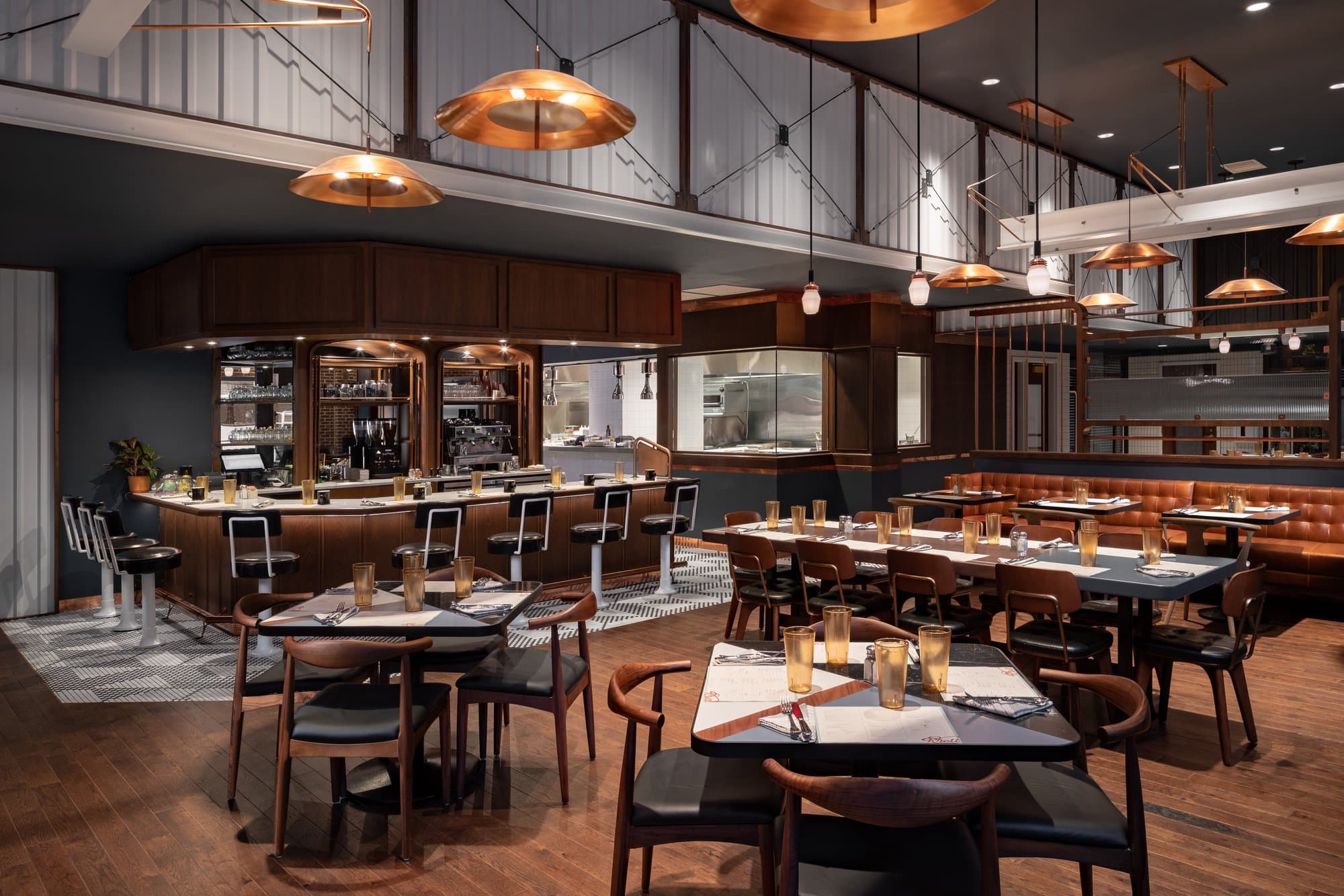 Hotel bar/restaurant with ornate light fixtures and a high-end industrial feel. 