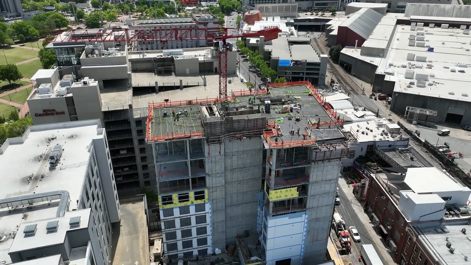 First frame of a drone video showing a skyscraper under construction