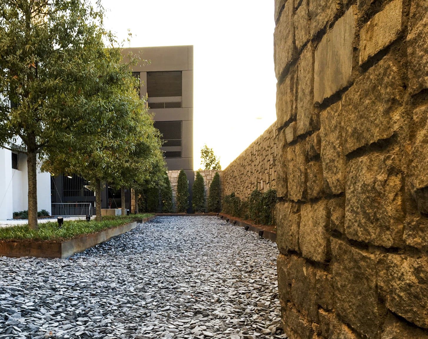 Courtyard in back of office with rocks and trees.