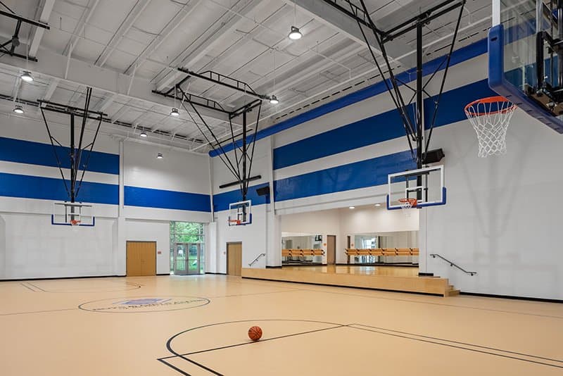 indoor basketball court. a dance studio can be seen in the background