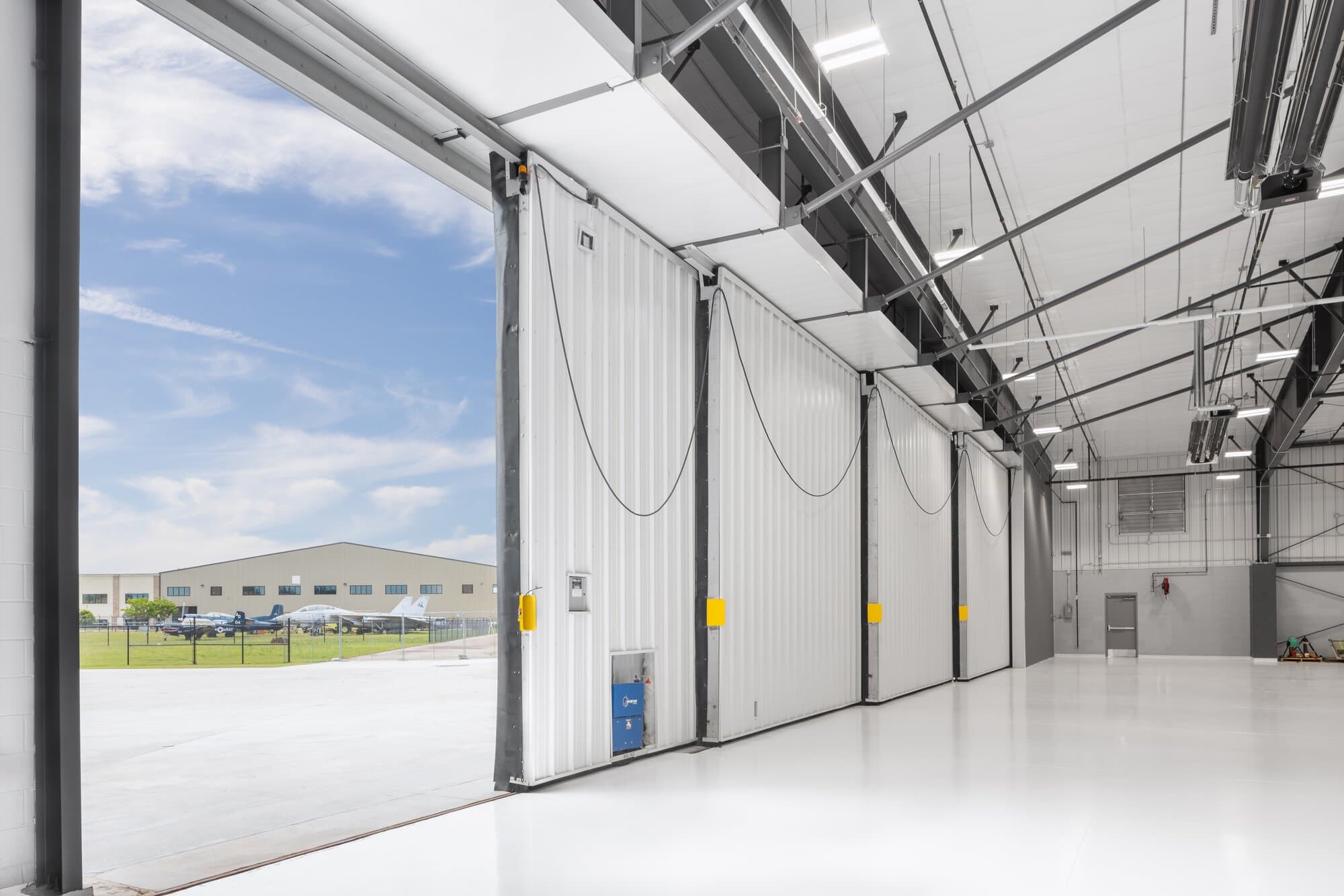 Airplane hangar attached to side of building.