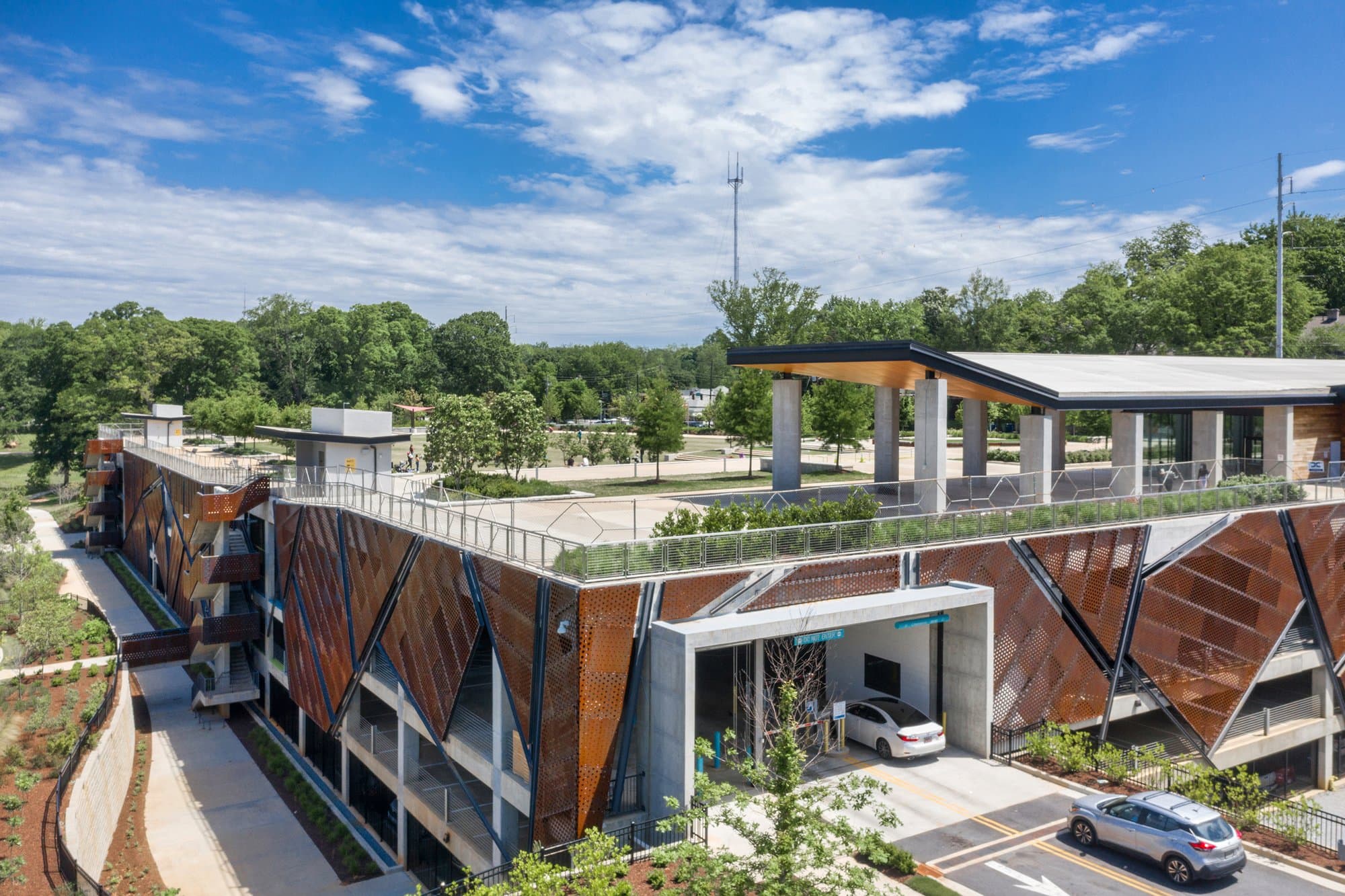 Aerial angle rendering of parking garage and grassy area.